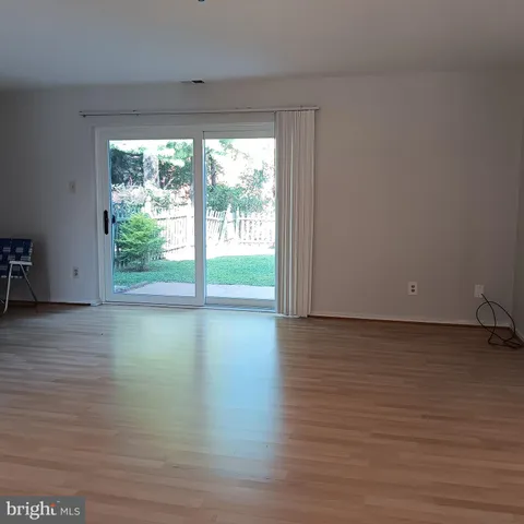 a view of a room with wooden floor and window