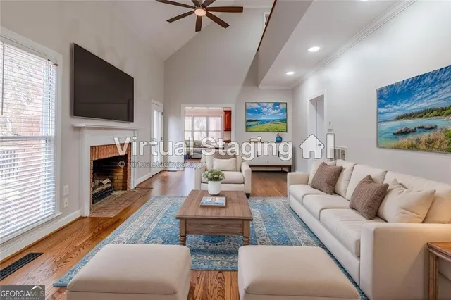 a living room with furniture a flat screen tv and a fireplace