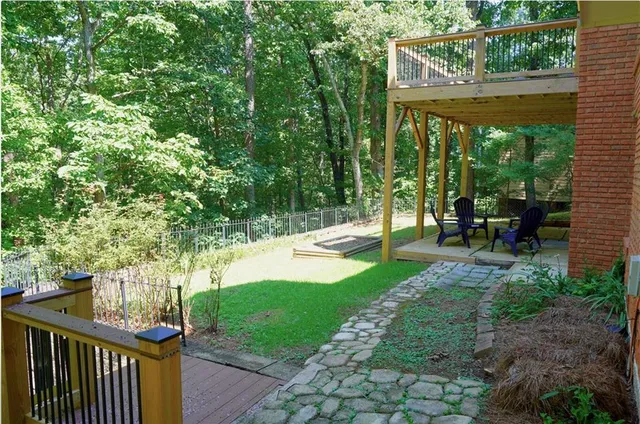 a view of a porch with chairs and backyard