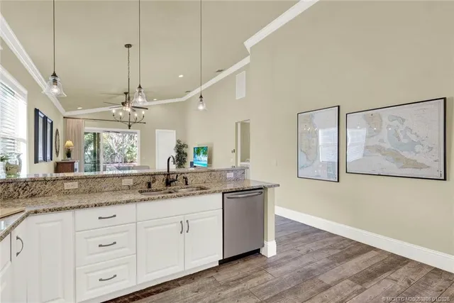 a kitchen with a table chairs stove and wooden floor