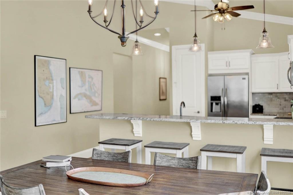 424 Southwest Camden Avenue Stuart, FL 34994 - Photo 15 of 58 a kitchen with a table chairs stove and wooden floor