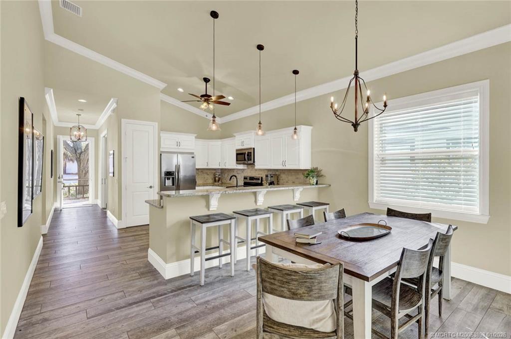424 Southwest Camden Avenue Stuart, FL 34994 - Photo 17 of 58 a view of a dining room with furniture window and wooden floor