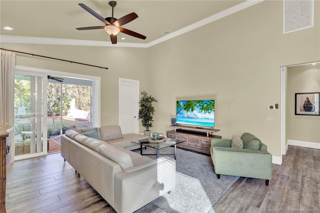 424 Southwest Camden Avenue Stuart, FL 34994 - Photo 21 of 58 a living room with furniture a flat screen tv and a large window