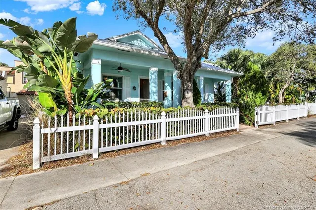 a view of a house with a small yard and plants