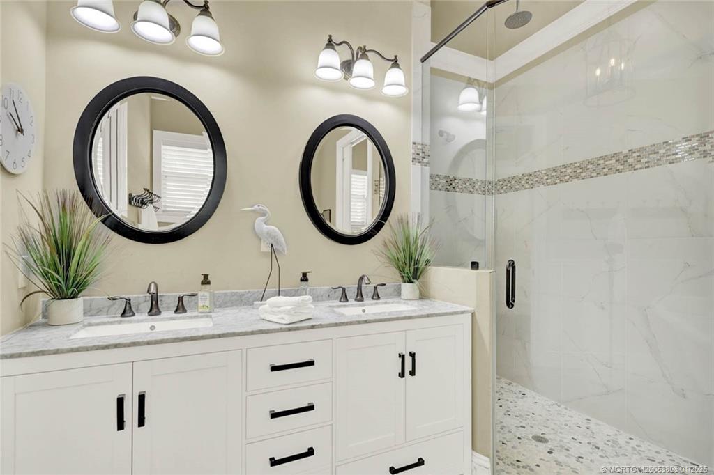 424 Southwest Camden Avenue Stuart, FL 34994 - Photo 32 of 58 a bathroom with a double vanity sink and a mirror