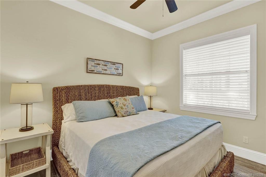 424 Southwest Camden Avenue Stuart, FL 34994 - Photo 34 of 58 a bedroom with a bed and a lamp