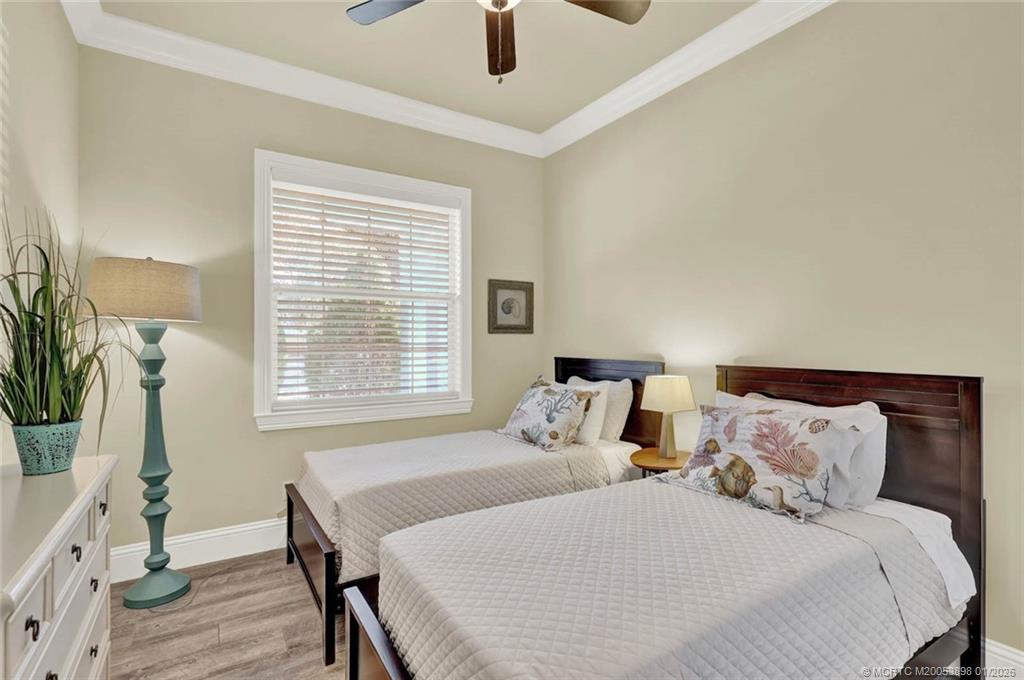 424 Southwest Camden Avenue Stuart, FL 34994 - Photo 37 of 58 a bedroom with a bed a window and potted plant on the dresser