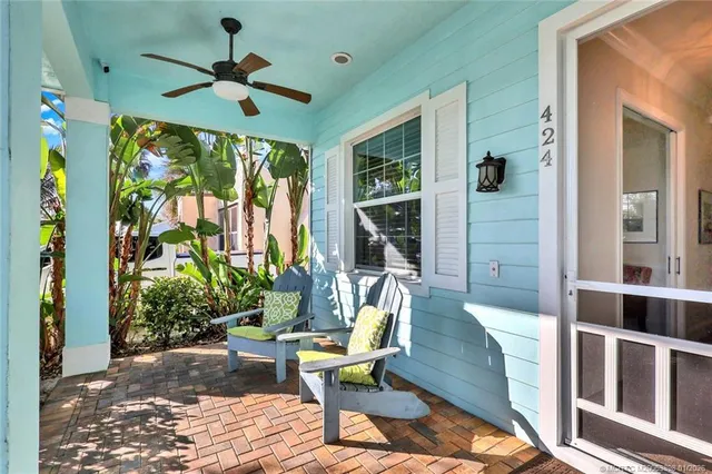 a living room with furniture a window and a flat screen tv