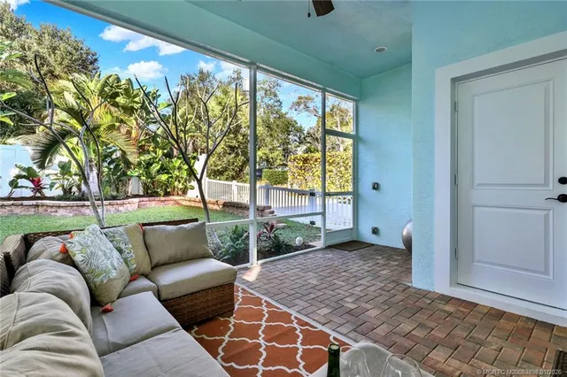 a view of a chair and table in backyard of the house