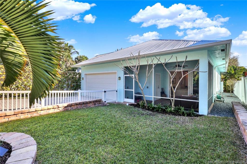 424 Southwest Camden Avenue Stuart, FL 34994 - Photo 50 of 58 a view of a chair and table in backyard of the house