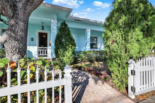a view of a house with wooden fence