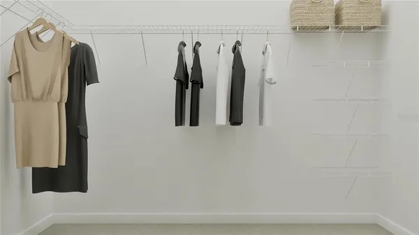 a view of walk in closet with clothes