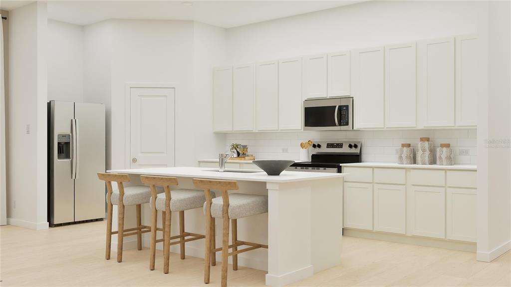 3070 Granite Rdg Avenue Minneola, FL 34715 - Photo 4 of 18 a kitchen with stainless steel appliances a stove a sink white cabinets and a refrigerator