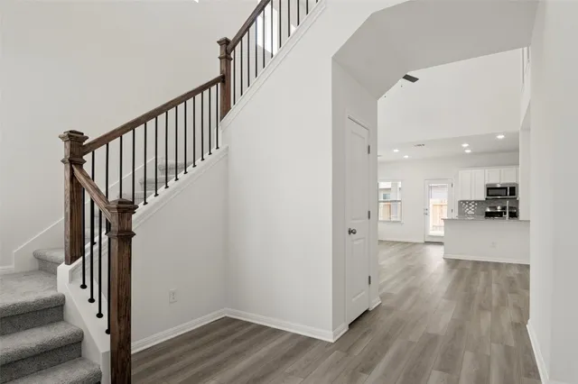a view of entryway with stairs and wooden floor