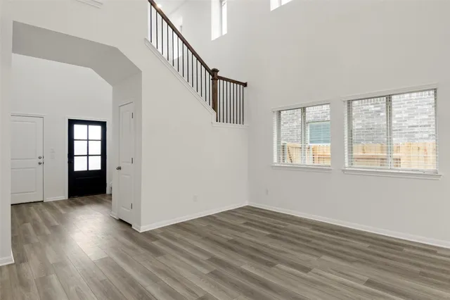 a view of kitchen with wooden floor and electronic appliances