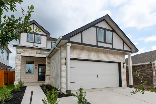 a front view of a house with a garage