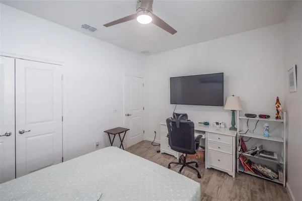 a bedroom with a workspace