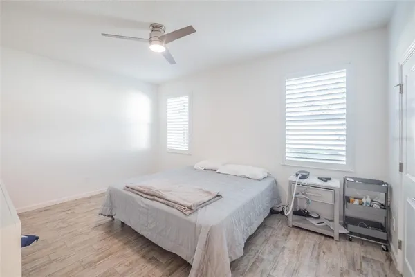 a bedroom with a bed a dresser and a window