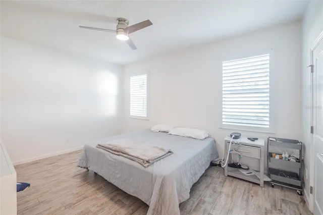 a bedroom with a bed a dresser and a window