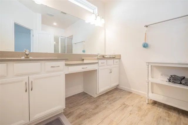 a view of cabinets a sink and a stove in a room