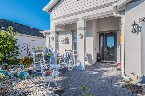 a view of house with patio outdoor dining space and glass windows