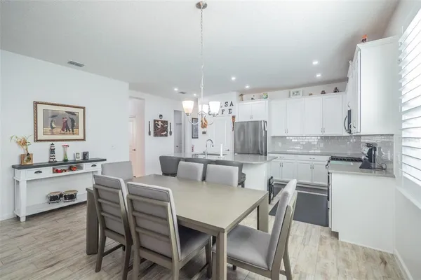 a large kitchen with a table and chairs