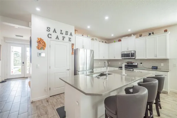a kitchen with stainless steel appliances granite countertop a sink and refrigerator