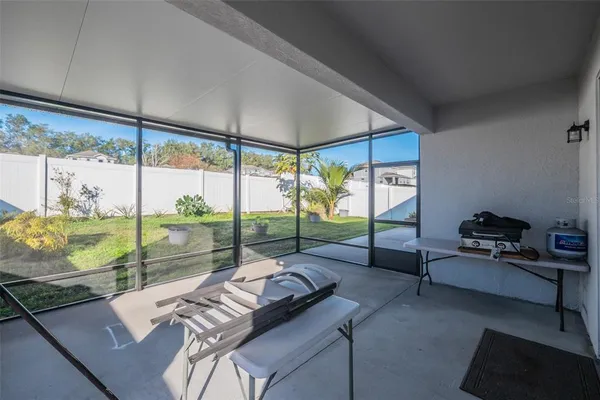a living room with furniture and a floor to ceiling window