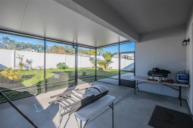 a living room with furniture and a floor to ceiling window