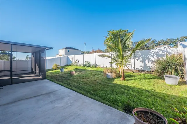 a swimming pool with outdoor seating and yard