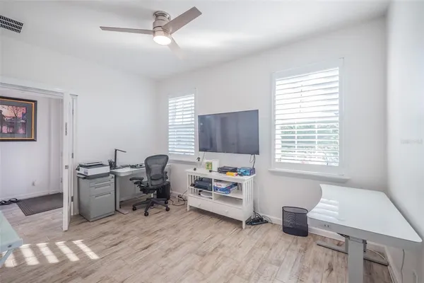 a view of a workspace with furniture and a window