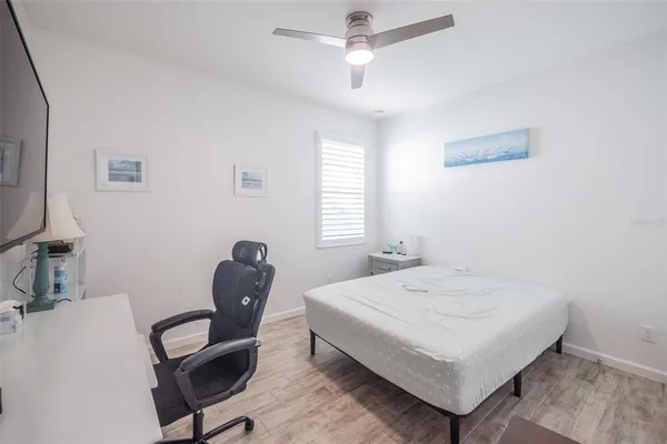 a bedroom with a bed and a chair