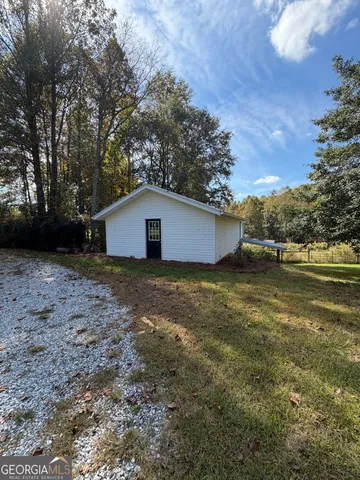 a view of a backyard with large trees