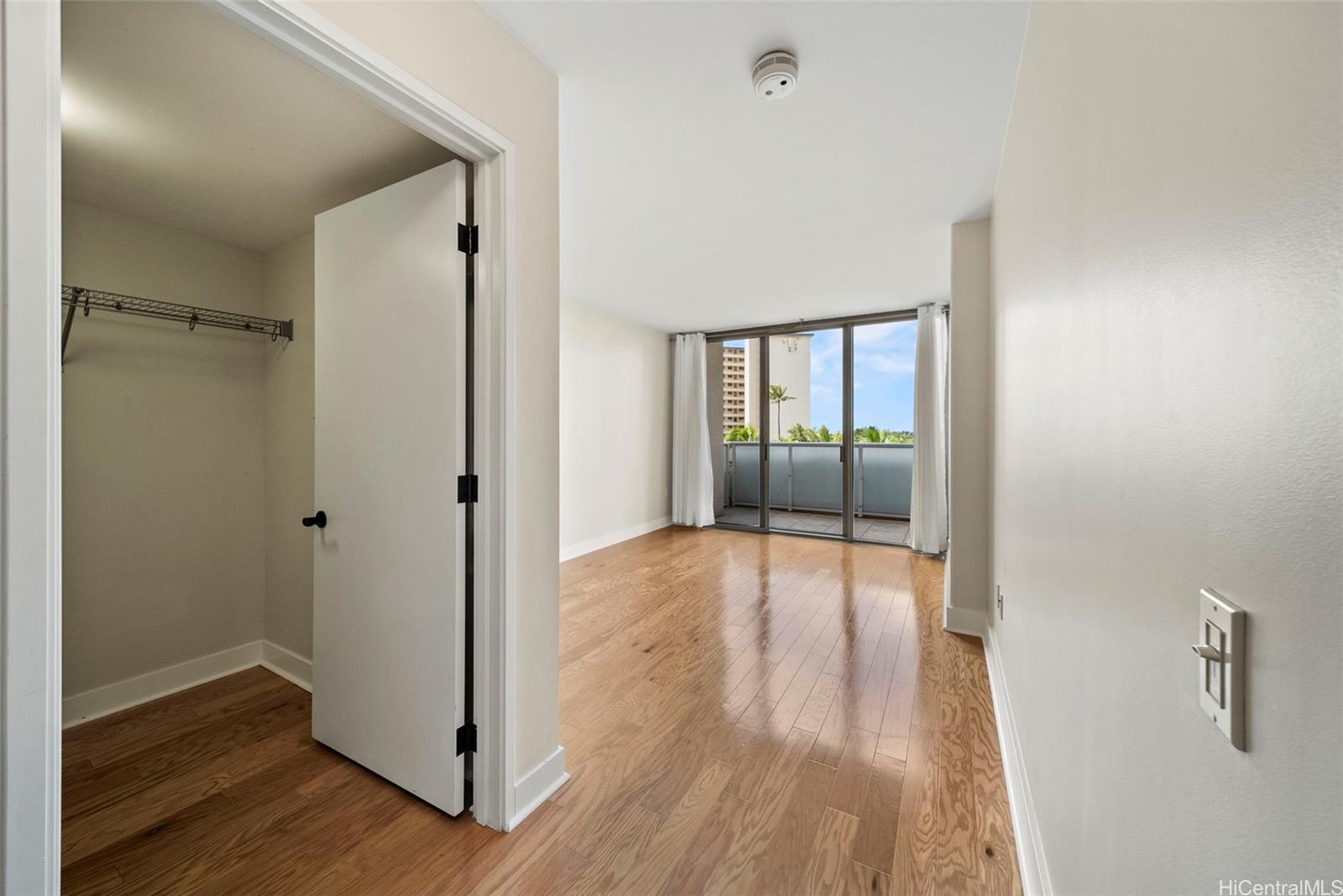1551 Ala Wai Boulevard, Unit 504 Honolulu, HI 96815 - Photo 14 of 25 a view of empty room with wooden floor and fan
