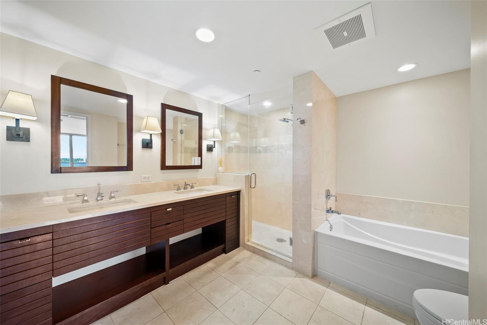 1551 Ala Wai Boulevard, Unit 504 Honolulu, HI 96815 - Photo 17 of 25 a spacious bathroom with a tub sink shower and mirror