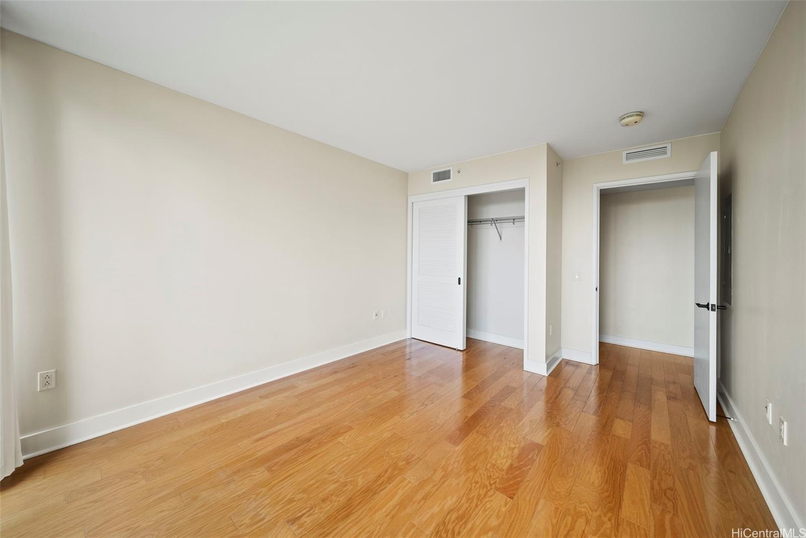 1551 Ala Wai Boulevard, Unit 504 Honolulu, HI 96815 - Photo 19 of 25 a view of an empty room with wooden floor