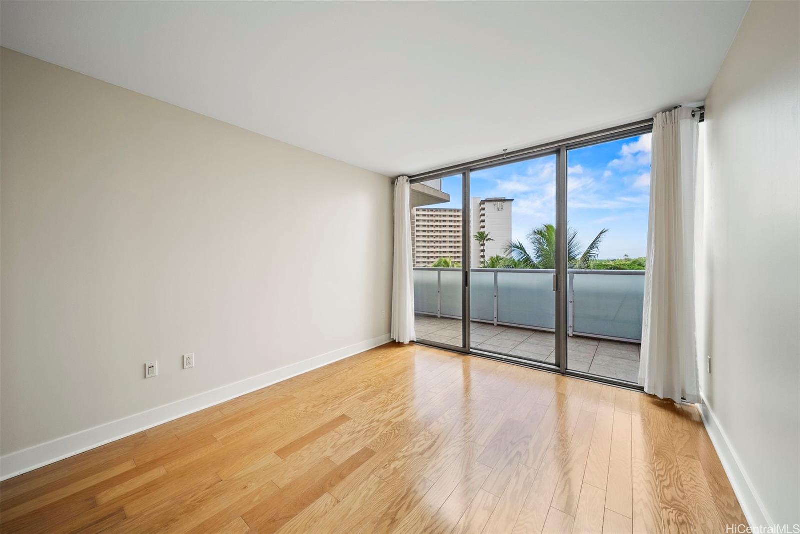1551 Ala Wai Boulevard, Unit 504 Honolulu, HI 96815 - Photo 20 of 25 wooden floor in an empty room with a window