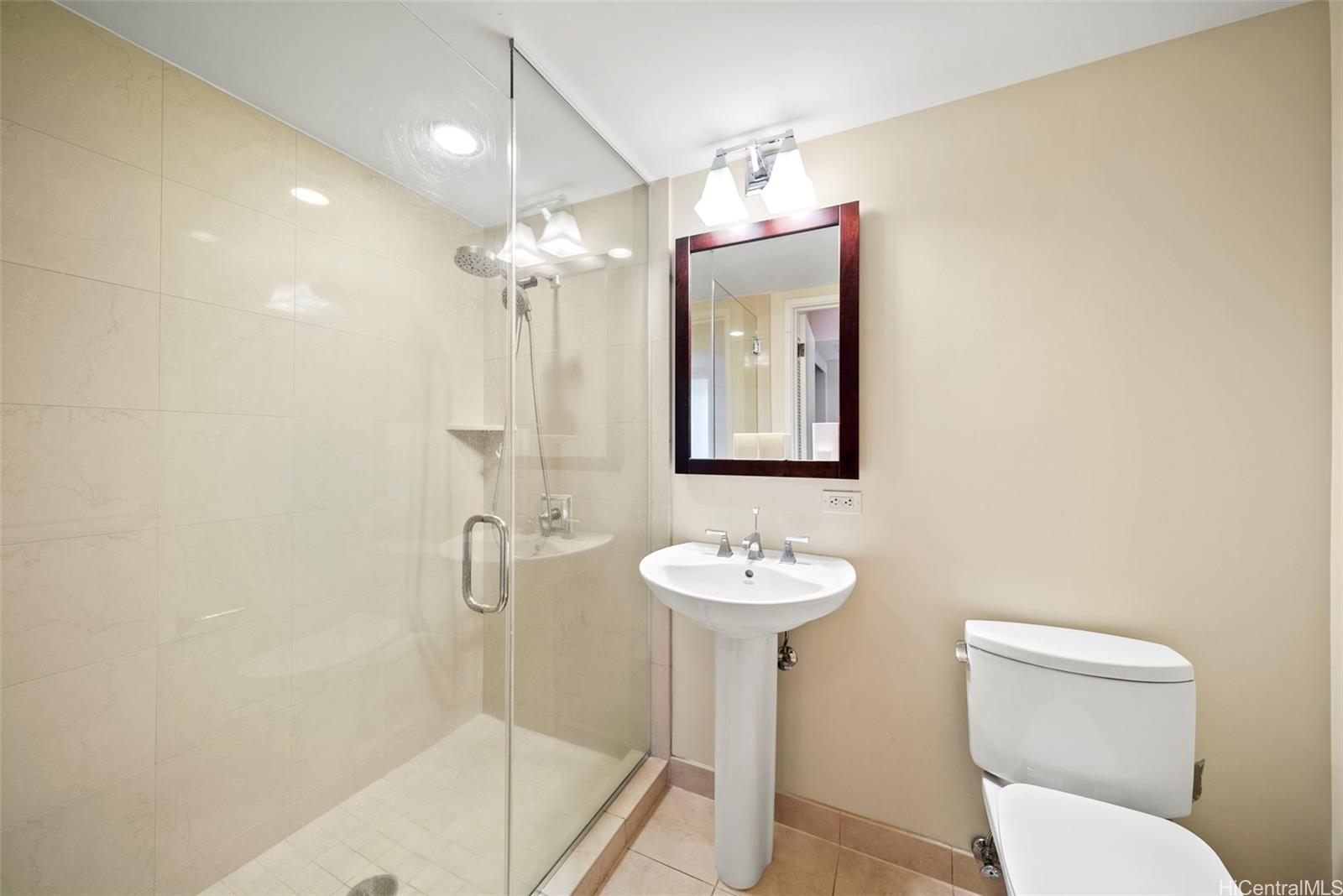 1551 Ala Wai Boulevard, Unit 504 Honolulu, HI 96815 - Photo 21 of 25 a bathroom with a toilet sink and mirror
