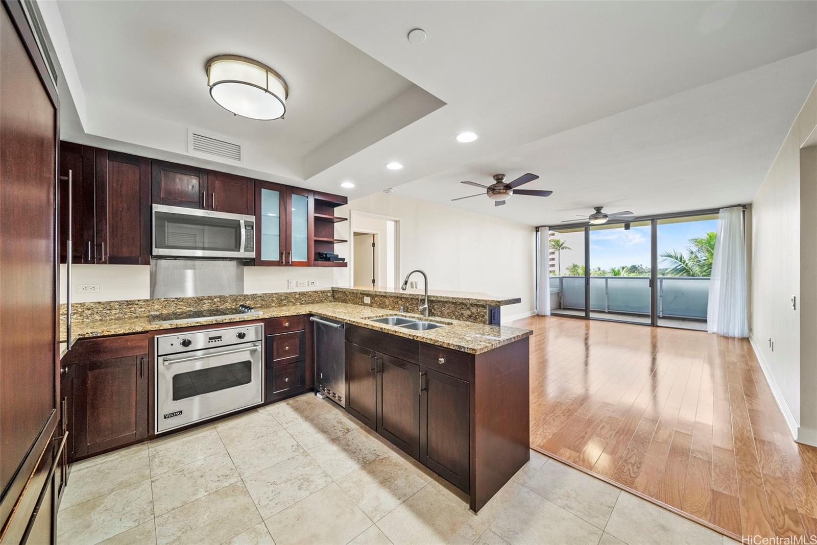 1551 Ala Wai Boulevard, Unit 504 Honolulu, HI 96815 - Photo 9 of 25 a large kitchen with stainless steel appliances granite countertop a stove and a sink
