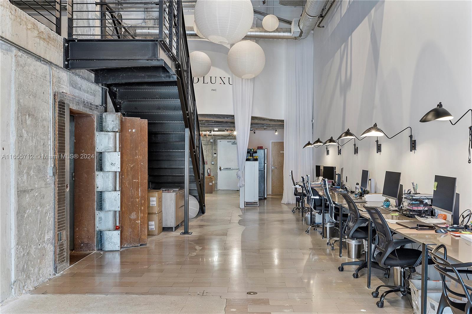 8101 Biscayne Boulevard, Unit C3 Miami, FL 33138 - Photo 11 of 25 a view of a livingroom and dinning room with wooden floor