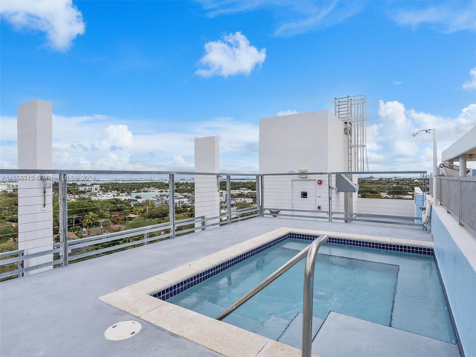 8101 Biscayne Boulevard, Unit C3 Miami, FL 33138 - Photo 15 of 25 a large kitchen with kitchen island stainless steel appliances a stove and a counter top space