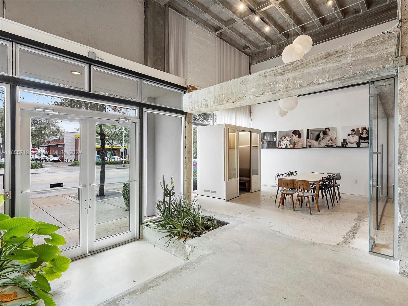 8101 Biscayne Boulevard, Unit C3 Miami, FL 33138 - Photo 2 of 25 a view of a porch with dining table and chairs