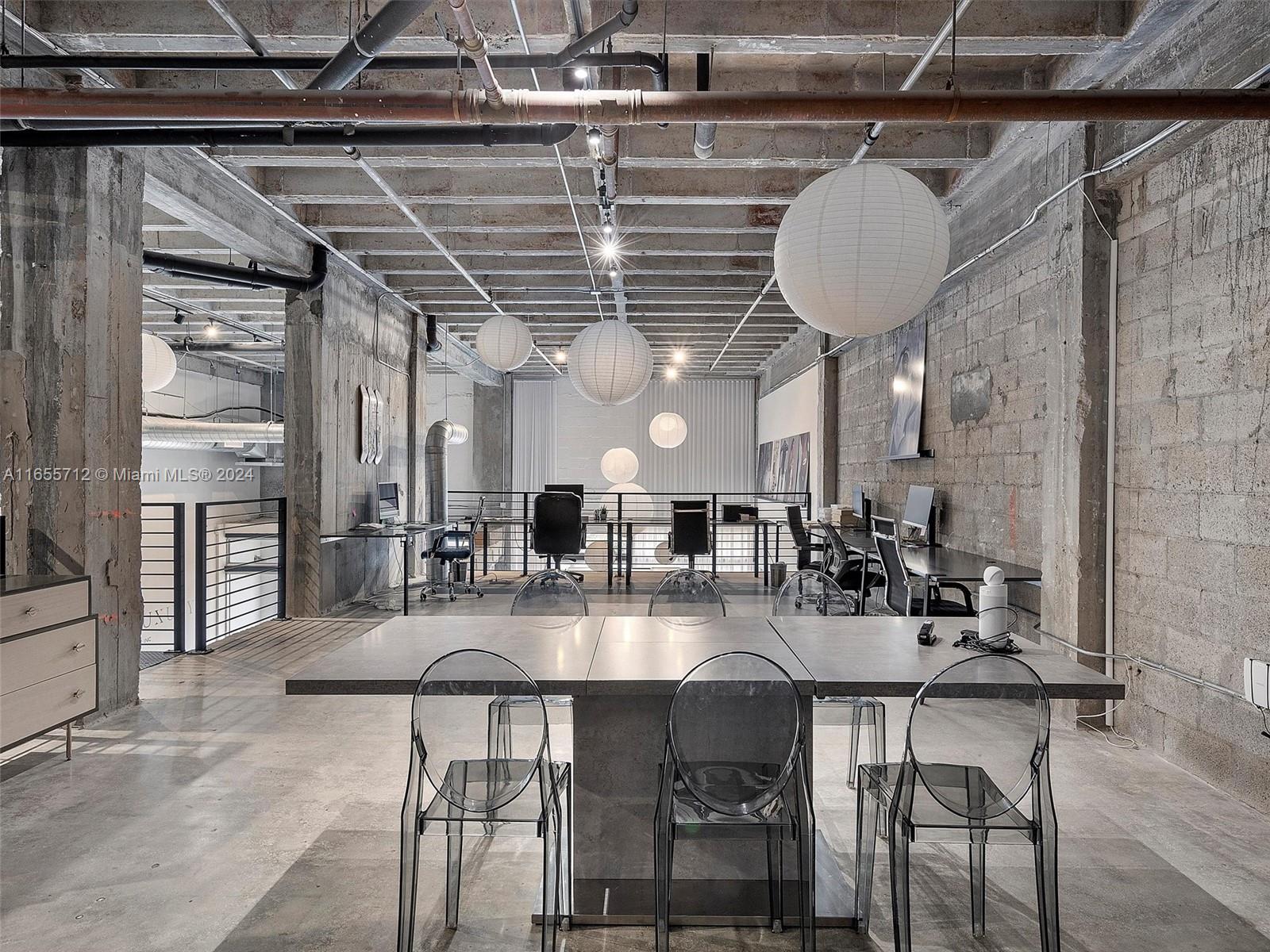 8101 Biscayne Boulevard, Unit C3 Miami, FL 33138 - Photo 21 of 25 a kitchen with a table and chairs in it