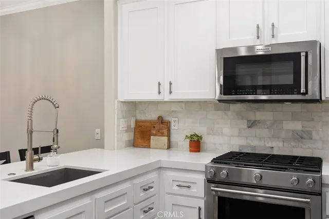 a kitchen with sink a microwave and stove