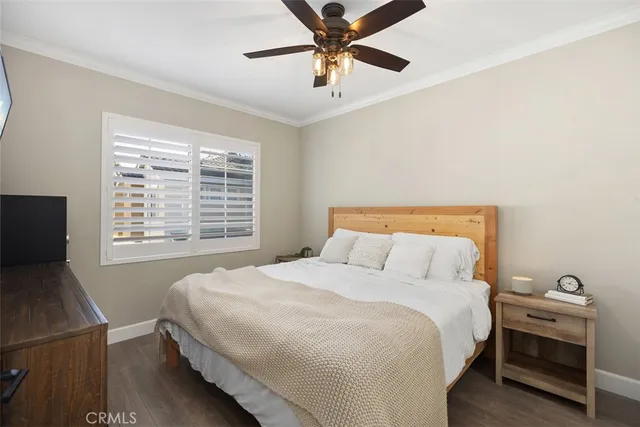 a bedroom with a bed and a tv