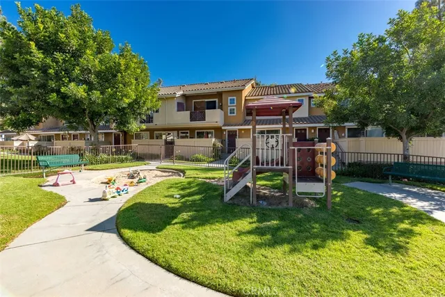 a view of a house with a yard patio and swimming pool