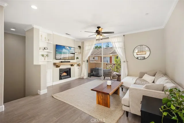 a living room with furniture a fireplace and a kitchen view