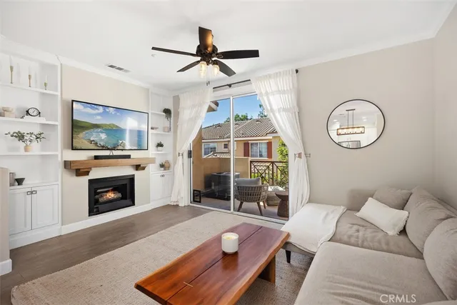a living room with furniture a fireplace and a flat screen tv