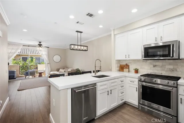 a kitchen with a sink stove and microwave