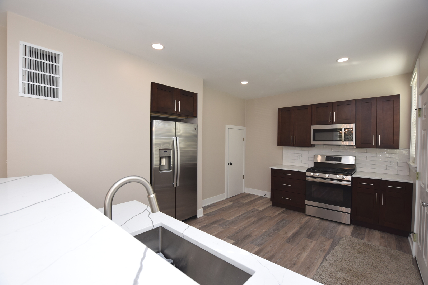 97 Gates Street Crystal Lake, IL 60014 - Photo 2 of 22 a kitchen with stainless steel appliances granite countertop a refrigerator and a stove top oven